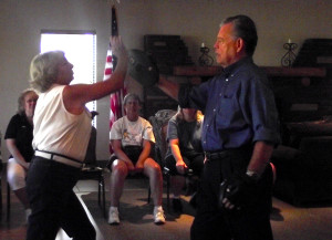 Peggy Pope and John Hughes demonstrate an upper strike using the palm of the hand.  A strike such as this can be effective to use toward the chin or the nose of an attacker.