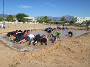 Participants gather inside the water-filled volleyball court to see who can do the most pushups. Photo by Stephanie Frehner. 
