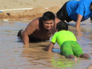 Joe Aquino and his son, Aayden positioned themselves for center stage, right in the middle of the volleyball court Friday, which proved beneficial as Aayden won the pushup competition, doing more pushups longer than the others. Photo by Stephanie Frehner.