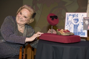 Rose Marie poses with a hair bow and shoes from her Baby Rose Marie days donated to the Smithsonian's Museum of American History in 2008