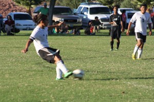 Bulldog Gabe Medina blasts a free kick by the Cowboy goalie to tie the match 1-1 Monday afternoon during the Dawgs 4-1 loss. Photo by Lou Martin