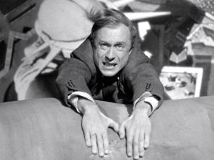 Publicity still of Norman Lloyd scene from Sabetour clinging to the top of the Statue of Liberty.