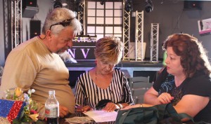 From left to right, Larry LeMieux, Geni Barton and Cindi Delaney go over the script and events prior to last Saturday’s Gala. Photo by Jim Lavender.