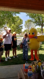 Blake Syndergaard and Nancy Hewett with the Mesquite Chamber, left, congratulate the race winner, Loretta Green, right as she stands with Derby the Duck. Green’s husband was the big winner of the day as three of his six ducks won prizes. Photo by Stephanie Frehner. 