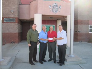 OPD officials present check to VVHS staff. Submitted photo