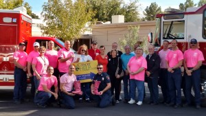 Crew members with Mesquite Fire & Rescue as well as City Officials and cancer survivors joined to present a check from MFR for their Pink Boot Drive that was held the last week in October. Photo by Stephanie Frehner. 
