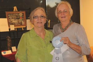 Jean Wiensch, left, presents Jean Battaglia with the People’s Choice Award at the October Mesquite Fine Arts Gallery reception on Thursday, Oct. 22. Photo by Barbara Ellestad.
