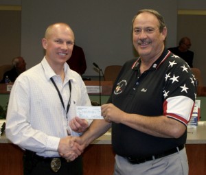 Mesquite Police Department Deputy Chief Scott Taylor, left, receives $1,800 from Elks Lodge #2811 Rick McDonald, Elks Exalted Ruler for the annual Shop with a Cop program. Photo submitted.