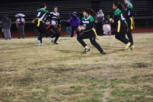 Bulldog Katie Zuniga races around left end for a long gainer during the Lady Dawgs win over Sunrise Mountain Friday night, Dec. 11. The Dawgs prevailed 32-6 on a cold wet night behind two T.D.’s from Zuniga. Photo by Lou Martin.