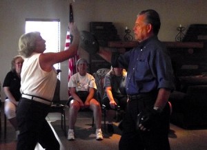 Peggy Pope and John Hughes demonstrate an upper strike using the palm of the hand. A strike such as this can be effective to use toward the chin or the nose of an attacker at a previous self-defense class. Photo by Teri Nehrenz. 