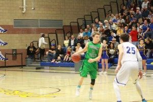 Bulldog point guard Jarrett Tietjen #2 looks over the Pirates defense during the Dawgs 42-38 loss at Moapa Valley Friday night. Tietjen had 10 points to lead the Dawgs. Photo by Lou Martin