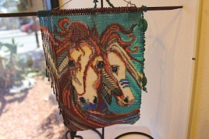 “Painted Ponies” is just one of the brilliantly beaded pieces by mixed media artist Karron Knight.  You can see Knight’s jewelry on display anytime at the museum but the pieces on display during the Art Walk are definitely worth taking a second look at.  Photo by Teri Nehrenz