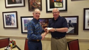 George Gault, Mesquite Regional Business Inc. CEO, left, accepts a $2,000 investment from Steve Arbour who represents American Bank of the North on Wednesday, March 9. 