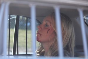 The ‘drunk driver’ of the ‘Every 15 Minute’ program sits in the back of the Mesquite Police car waiting for her trip to jail for her staged drunk driving accident.  Photo by Teri Nehrenz 