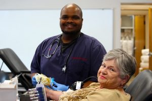 Red Cross employee Darryl Thompson sets up long time blood donor Lois West in her first visit to the Primex location during their annual blood drive held on June 2.  Photo by Teri Nehrenz