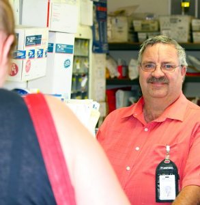 Douglas Adriance, Postmaster in Littlefield, AZ was recently named Postmaster of the Year by the National League of Postmasters Arizona Chapter.  Adriance is photographed helping an Arizona resident with her postal needs.  Photo by Teri Nehrenz