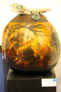 A carved gourd by artist Janet Trobough titled ‘Runs with the Wind’ is further adorned with native wood and turquoise stones.  Photo by Teri Nehrenz
