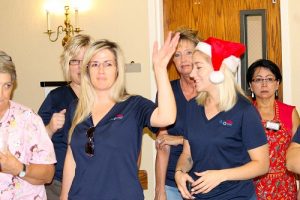 Santa’s Helpers from Colonial Property Management spread holiday cheer throughout the halls of Highland Manor as they helped residents celebrate Christmas in July on July 27.  Photo by Teri Nehrenz