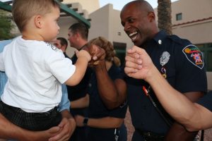 Children are warmly welcomed by Mesquite firefighters including Jason Blakely, right, to a September 11 commemoration ceremony held at City Hall. Photo by Barbara Ellestad.