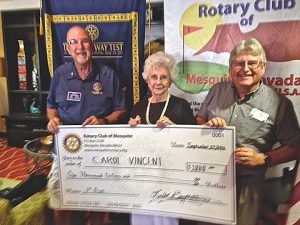 Rotary Assistant Governor Jake Noll presents Carol Vincent her check assisted by Jeff Bird who sold the winning ticket. Photo by Burton Weast
