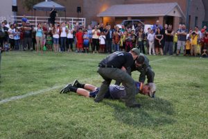 Virgin Valley High School Senior Reid Jensen volunteered to be tazed at this year’s Mesquite Night Out on Sept. 21. Jensen was talked into it by his brother-in-law Quinn Averett, who is currently the Public Information Officer with Mesquite Police Department. Jensen said he volunteered because “I thought it would be real cool to do it,” he said. “I couldn’t really move.” Thankfully, the effects of the paralyzing tazor wore off before his performance at the football game two days later where he plays as a tight end. After high school, Jensen will depart for a two-year mission. Averett told the MLN that the amount of power in this instance was about 10,000 watts. “The stun mimics the central nervous system, and while the person cannot move or talk, they can still think and breathe. We usually only have to use extreme force like this two to three times per year, which considering the amount of arrests and incidents, is very low.” Photo by Stephanie Clark.  