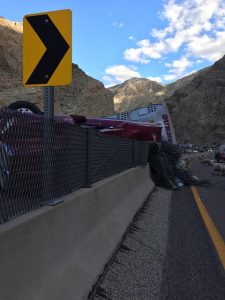 A semi-truck carrying a load of pigs experienced a mechanical failure Monday afternoon while travelling southbound on I-15 through the Virgin River Gorge, overturning and gathering 400 feet of glare screen with it. Submitted Photo.