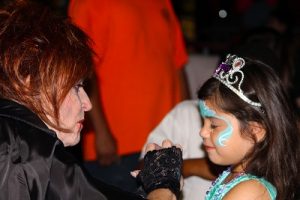Vampire, Barbara Vacarro, provided some talent and color with a variety of facepainting designs. Vacarro prettied up the princesses as nicely as she grossed up the ghouls. Photo by Teri Nehrenz